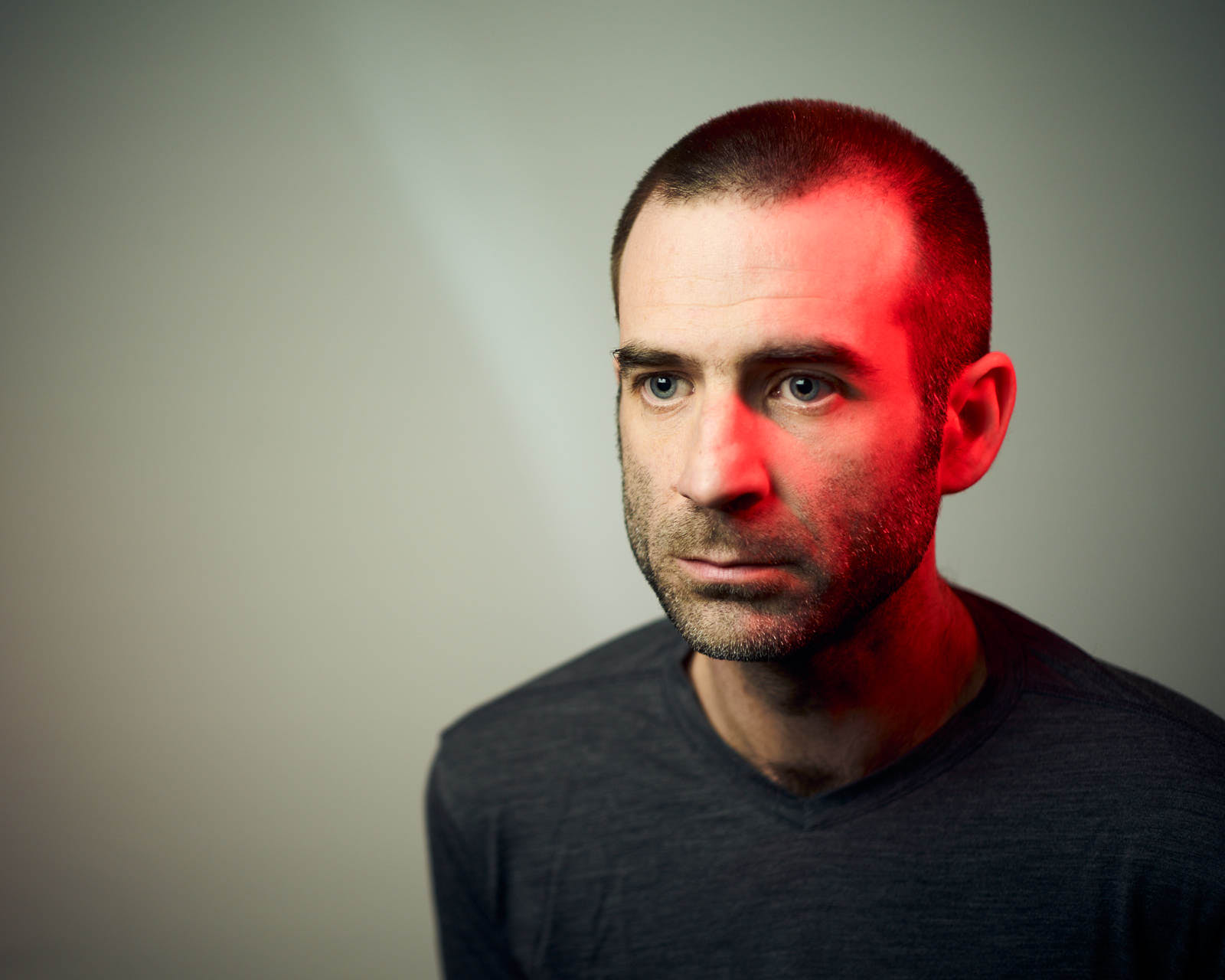 portrait of a man with red light using a leica m and a summicron 50mm