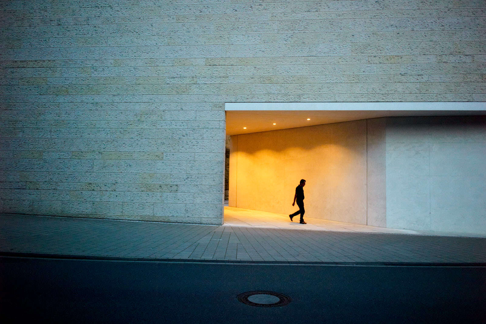 silhouette in front of the lwl museum in munster germany at night