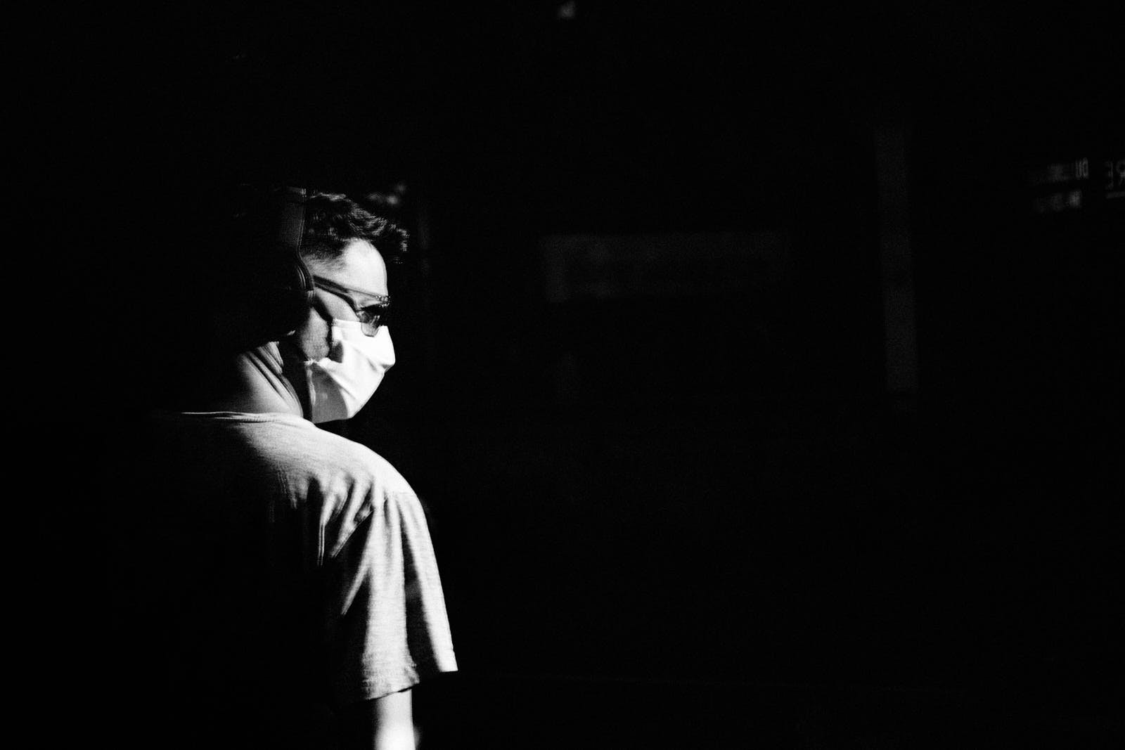 street portrait of a man with face mask from behind
